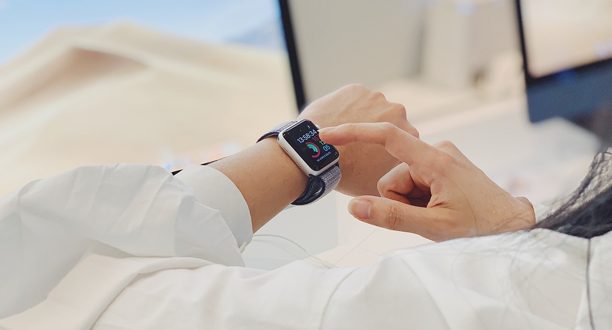 Woman wearing an iWatch checking her activity